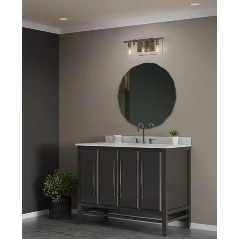 Glayse Collection 3-Light Clear Glass Luxe Bath Vanity Light in Brushed Nickel above dark vanity in modern bathroom