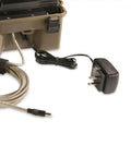 Rugged 12 Volt Battery Box For Trail Cameras with charger cord, sealed case, and protective strap for outdoor use.