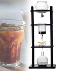Slick Slow Drip Cold Brew Maker With Thick Glass Carafe Rustic Pine Base, six cup capacity system on counter.