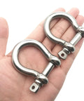 Two Pack Three Eighth Inch Screw Pin Anchor Shackle Premium 304 Stainless Steel Heavy Duty Rigging in a hand.