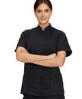 Women Short Sleeve Chef Coat In Sleek Black Legit Culinary Jacket With Heavy Duty Cotton Poly Blend side view model wearing chef coat
