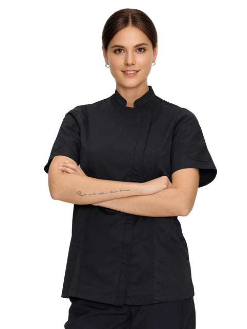 Women Short Sleeve Chef Coat In Sleek Black Legit Culinary Jacket With Heavy Duty Cotton Poly Blend side view model wearing chef coat