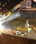 Close-up of Six Pack Magnetic Welding Clamp Set With Ground Clamp and support in use on metal surface, emitting sparks.
