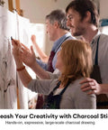 Three people sketching on large canvases using Compressed Graphite And Charcoal Sticks Set Of 18 For Drawing And Sketching.