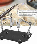 Heavy Duty Auxiliary Jewelry Welding Work Clip With Angle Adjustable Third Hand For Soldering Maintenance And Modeling Tasks In Workshop  on a black base with metal arms securing a small object.