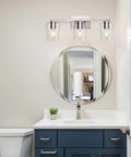Three Light Vanity Wall Light in Brushed Nickel for Bathroom Over Mirror, showcasing modern design with glass shades