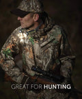 Man wearing camouflage holding a rifle with Hands Free Neck Light For Camping Hunting And Work, rugged design illuminated in forest.