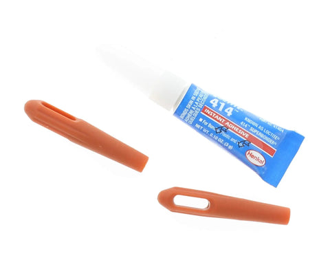 Tube of instant adhesive with two orange applicator tips on white background