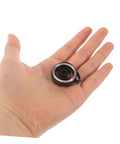 Hand holding a precision spring from Pro Grade Mechanical Alarm Clock Repair Kit With Precision Springs And Winding Key Assembly