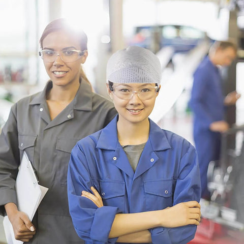 Two workers in factory setting, woman wearing Anti Static Cleanroom Hat Breathable Working Cap Lightweight Protective Headwear.