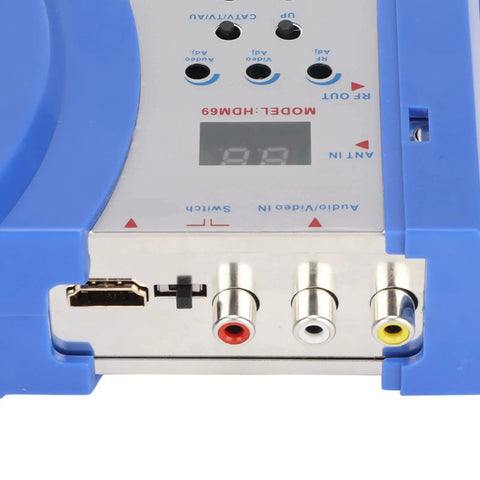 Close-up of HDMI to RF modulator connectors showing composite inputs and HDMI port for PAL NTSC support with dual frequency.