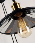 Dope Vintage Wall Sconce Featuring Classic Wrought Iron Build With Handsome Pulley Adjustment For Slick Loft Rooms And Chill Bar Decor That Seriously Slays And Looks Absolutely Lit, showcasing a brass socket with a glass bulb.