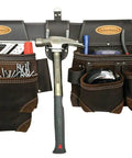 Durable Oil Tanned Leather Tool Rig With Large Capacity For Hand Tools And Fasteners Pro Grade Leather Tool Carrier Built For Pro Construction Jobs Easy Access Pocket Layout For Everyday Work shown with hammer and tools