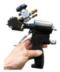 Professional PU Foam Spray Upgrade Gun With Air Purge Valve And Rugged Carrying Case For Smooth Polyurea Coating And Quick Cleanup Like A Boss On Construction Sites held in hand showing trigger and nozzle.