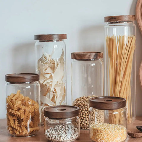 Top Shelf Airtight Glass Storage Jars With Smooth Acacia Wood Lids for pasta, beans, and grains in a kitchen setting.