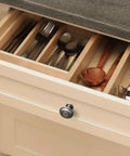 Straight Up Vintage Vibes With These Killer Weathered Nickel Cabinet Knobs packed in a kitchen drawer with utensils.