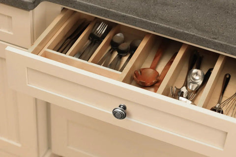 Straight Up Vintage Vibes With These Killer Weathered Nickel Cabinet Knobs packed in a kitchen drawer with utensils.