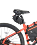 Waterproof Bike Seat Bag With TPU Welded Triangle Frame And YKK Zipper on a red bike, showcasing secure rear attachment.
