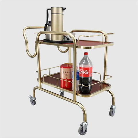 Slick Two Tier Serving Cart Crafted From Solid Stainless Steel Smooth Glide Casters And Top Handle No Sweat Moving Industrial Grade Rolling Rack For Home Bar Kitchen Or Commercial Wine Setup with beverages and teapot.