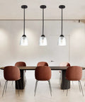 Four Pack Clear Seeded Glass Lamp Shade Replacements For Ceiling Fans Chandeliers Pendant Lights Vanity Lights And Kitchen Island Fixtures Fits Two And One Eighth Inch Fitter 4.76 Inch Diameter 5.47 Inch High illuminating a modern dining area.