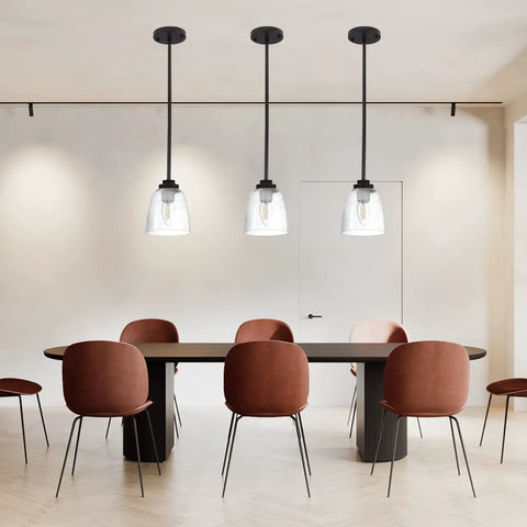 Four Pack Clear Seeded Glass Lamp Shade Replacements For Ceiling Fans Chandeliers Pendant Lights Vanity Lights And Kitchen Island Fixtures Fits Two And One Eighth Inch Fitter 4.76 Inch Diameter 5.47 Inch High illuminating a modern dining area.