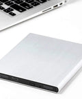 Premium Aluminum External USB 3.0 UHD 4K Blu Ray Writer Super Drive for PC and Mac with Plug and Play Setup, High Speed Data Transfer, Wide Compatibility, Portable Aluminum Enclosure for Laptops and Desktops, silver external drive beside laptop