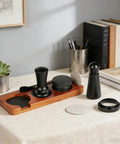 Crank Out Shop Quality Espresso Shots With This Premium 51Mm Tamper Set Including Seven Essential Tools A Smart Distribution Wand And Soft Counter Pad For Home Brewers on a kitchen table.
