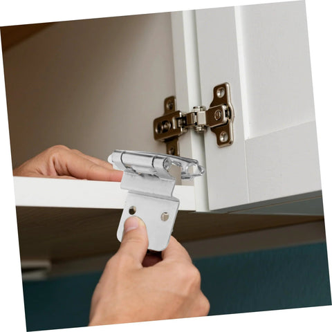 Hand installing silent self-closing cabinet hinges on white cabinet for easy and quiet operation, enhancing kitchen and bathroom furniture.