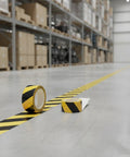 Top Shelf Yellow Floor Marker Tape With Hell Yeah Adhesion For Concrete And Epoxy Surfaces, rolls on warehouse floor.