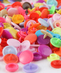 Close-up of colorful plastic snaps from All In One Snap Fastener Kit With Pliers, 400 Sets In 24 Colors Plastic Snaps For Clothing.