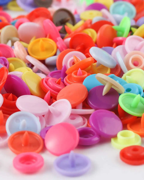 Close-up of colorful plastic snaps from All In One Snap Fastener Kit With Pliers, 400 Sets In 24 Colors Plastic Snaps For Clothing.