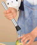 Person using 10 Inch Cocktail Muddler Set With 2 Stainless Steel Muddlers And 2 Long Handle Mixing Spoons For Mojitos And Fruit Drinks Home Bar Tool In Silver For Home Bartenders And Party Hosts pressing lime in glass