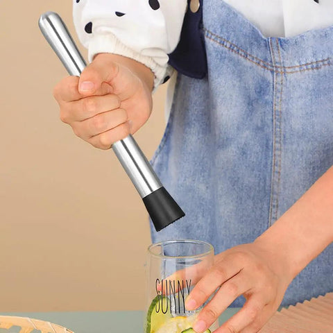 Person using 10 Inch Cocktail Muddler Set With 2 Stainless Steel Muddlers And 2 Long Handle Mixing Spoons For Mojitos And Fruit Drinks Home Bar Tool In Silver For Home Bartenders And Party Hosts pressing lime in glass