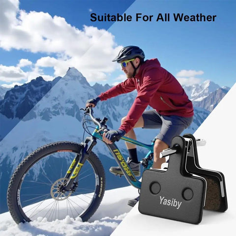 Image of a cyclist on a mountain with High Performance Disc Brake Pads For MTB Bikes With Installation Tools Four Pairs Semi Metallic And Organic Resin Replacement Compatible With TRP Tektro Shimano Deore Brakes in foreground.