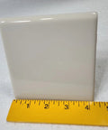 Beige Bone Almond Ceramic Bullnose Tile 4x4 Square Trim With Curved Edge 9 Piece Box Classic Color 006 placed near a ruler