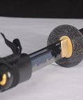 Close-up of Handmade Practice Katana For Iaido Training Full Tang Sharp Blade Japanese Samurai Sword with ornate tsuba.