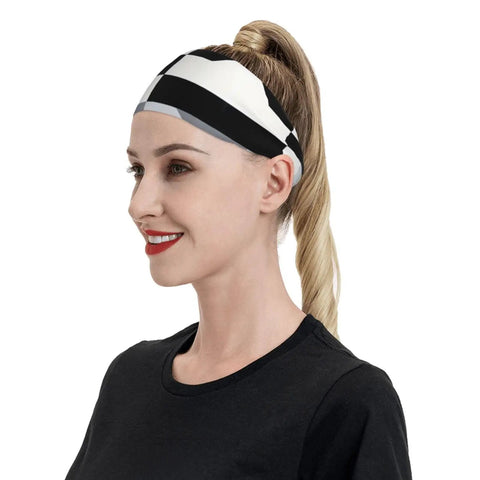 Fresh Black And White Piano Grid Print Sweatband Headband With Dope Stretchy Polyester Fabric For All Day Workout Comfort And Gym Vibes Plus Reliable Grip That Keeps Hair Back During Intense Training Sessions, worn by a woman with hair in a ponytail.