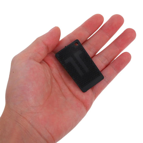 Hand holding a single black pad from 20 Pack Black Adjustable Furniture Leveling Pads Anti Slip Shims For Washing Machines Refrigerators Tables Sofas Cabinets And More To Level Up And Cut Vibration For A Wobble Free Home