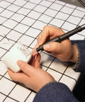 Person using Dead Nuts Tough 42 Inch Flexible Flex Shaft Rotary Tool Attachment Fits Dremel Mini Drill for detailed work.
