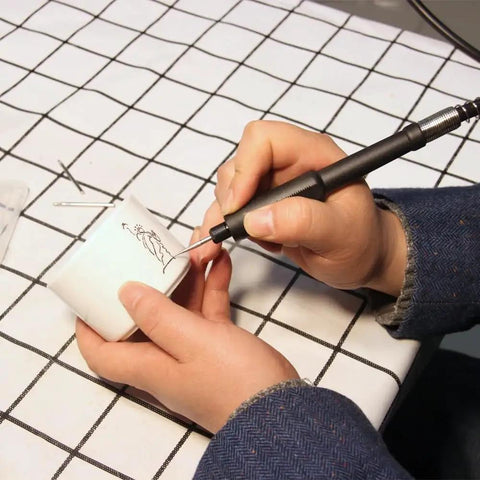 Person using Dead Nuts Tough 42 Inch Flexible Flex Shaft Rotary Tool Attachment Fits Dremel Mini Drill for detailed work.