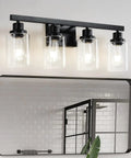 Top Shelf 4 Light Bathroom Vanity Light With Clear Glass Sleeves Matte Black Vintage Wall Sconce above a mirror.