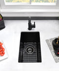 Top view of 18 Inch Drop-In Bar Sink Black Quartz Composite Single Bowl For Small Kitchens And RVs Durable Granite-Style Mini Sink With Bottom Grid And Drain Included Heat And Scratch Resistant Outdoor Ready installed in a countertop.