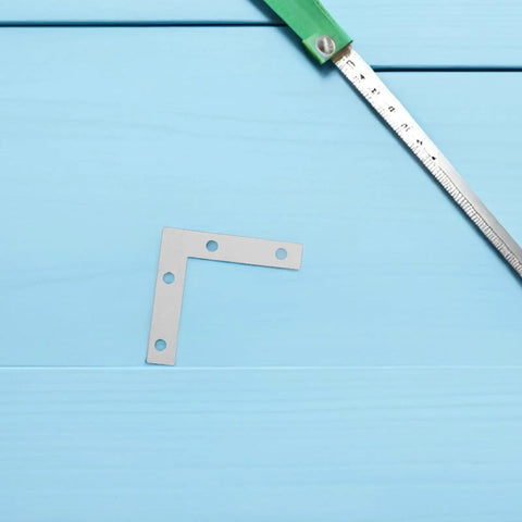 100 Pack Silver L Shape Corner Brackets For Wood And Frames Easy Install Right Angle Braces 2.17 Inch on blue surface with ruler
