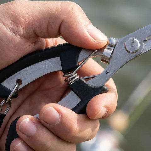 Close-up of hand holding 2 Pack Stainless Steel Fishing Pliers With Lanyard, Needle Nose Hook Remover Set.