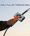 Compact Drill Powered Wire Puller Featuring Slick Conduit Fish Tape Grip Delivers No Sweat Wiring Performance For Home Renovation Tasks And Professional Electrical Projects Supporting Cables Up To Point Two Three Inches, hand holding tool.