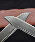 Close-up of Bart Cham Dao Damascus Steel Hand Made Sword blades with brown leather sheath for Wing Chun practice and martial arts training.