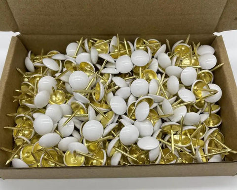 Hella Sturdy White Upholstery Tacks And Decorative Thumbtacks For Sofa Headboards And Furniture Trim With Top Shelf Hardware featuring a box full of white tacks with gold tips.