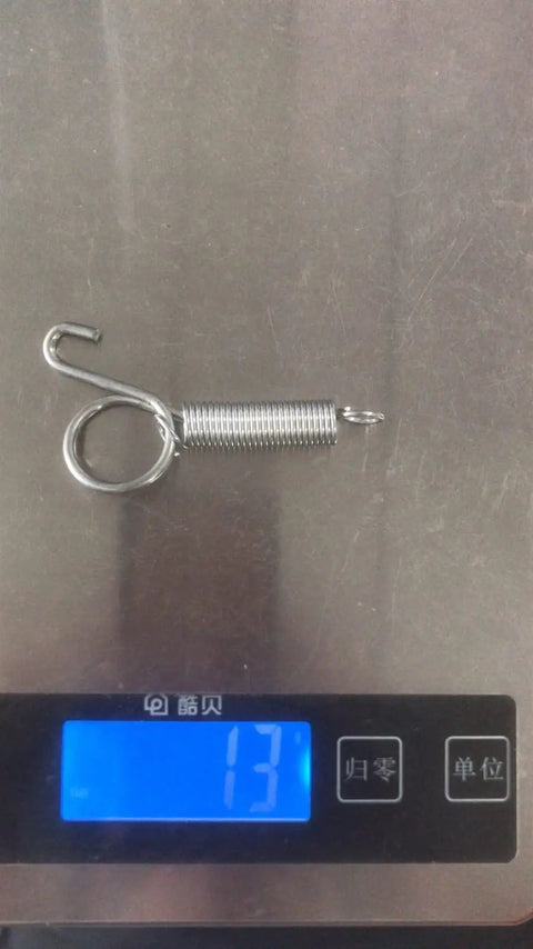 Heavy Duty Stainless Steel Sliding Bolt Latch For Rabbit Hutch Doors showing spring mechanism weighing 13 grams on scale.