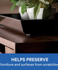 Close-up of a wooden cabinet with a black tray and plant, showcasing Clear Self Adhesive Cabinet Bumper Pads 40 Pack Half Inch Round Rubber Door Bumpers Noise Dampening and Scratch Protection for Cabinets and Drawers Transparent Protectors with Easy Install Non Slip Cushions.