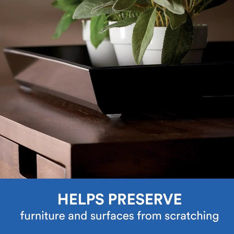 Close-up of a wooden cabinet with a black tray and plant, showcasing Clear Self Adhesive Cabinet Bumper Pads 40 Pack Half Inch Round Rubber Door Bumpers Noise Dampening and Scratch Protection for Cabinets and Drawers Transparent Protectors with Easy Install Non Slip Cushions.
